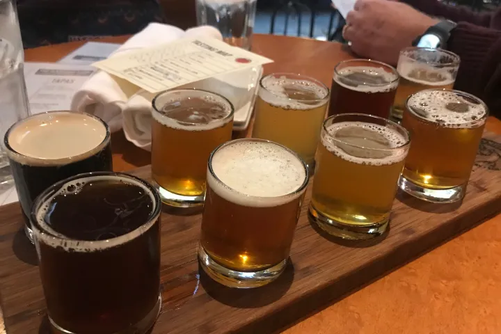 a cup of coffee and a glass of beer on a table