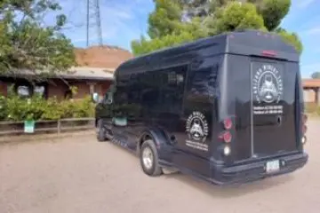 a group of people riding on the back of a truck
