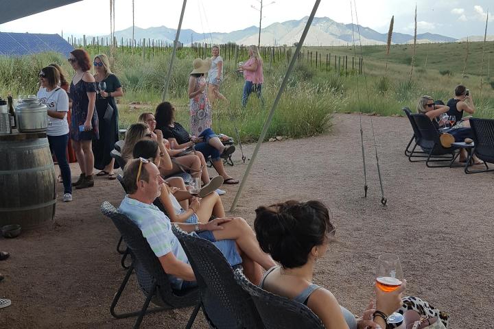 a group of people sitting at a beach