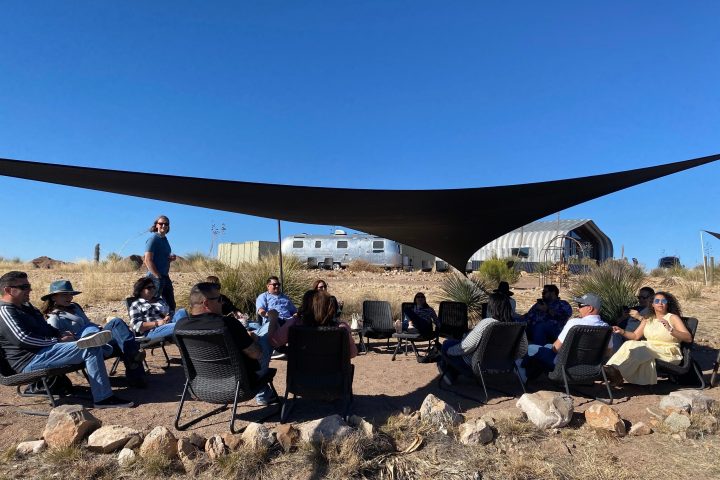 a group of people sitting at a beach